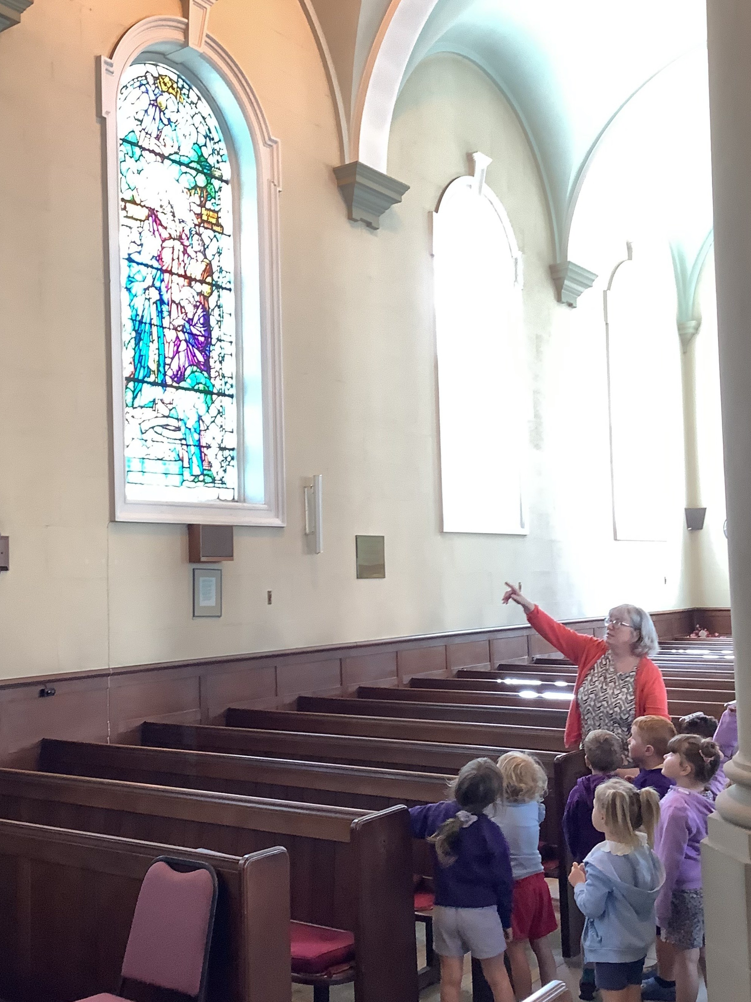Nursery Children looking at the stained glass windows.